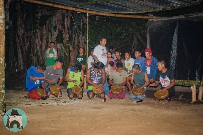 Cogon men playing the gongs